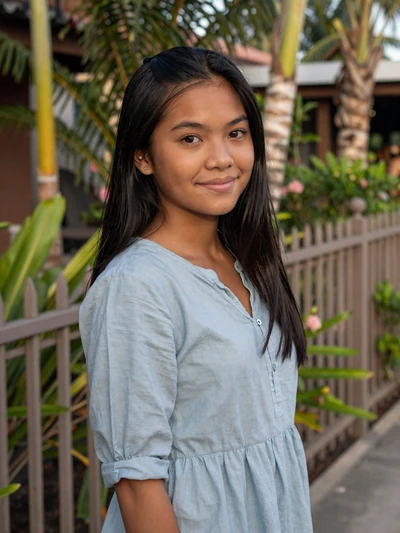 Maricel, 27, verified Filipina woman in light blue blouse near a tropical garden in Cebu