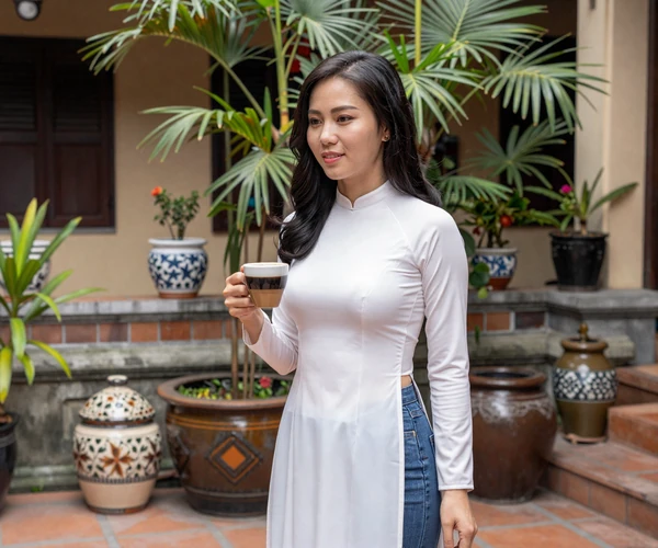 Vietnamese woman enjoying traditional coffee in courtyard representing warmth of Vietnamese dating culture
