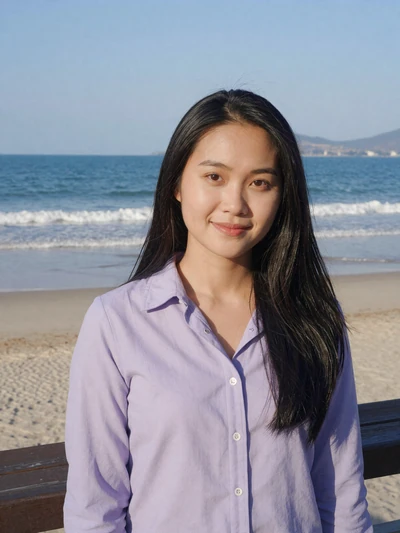 Mai, 29, verified Vietnamese woman in lavender shirt on Da Nang beach boardwalk with ocean backdrop