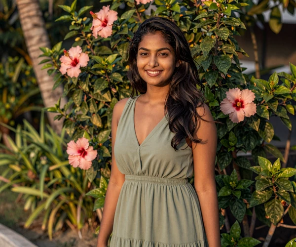 Maldivian woman in casual dress near tropical garden representing island dating culture