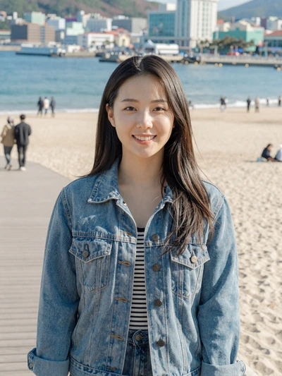 Nari, 27, verified Korean woman in denim jacket at Haeundae beach boardwalk in Busan